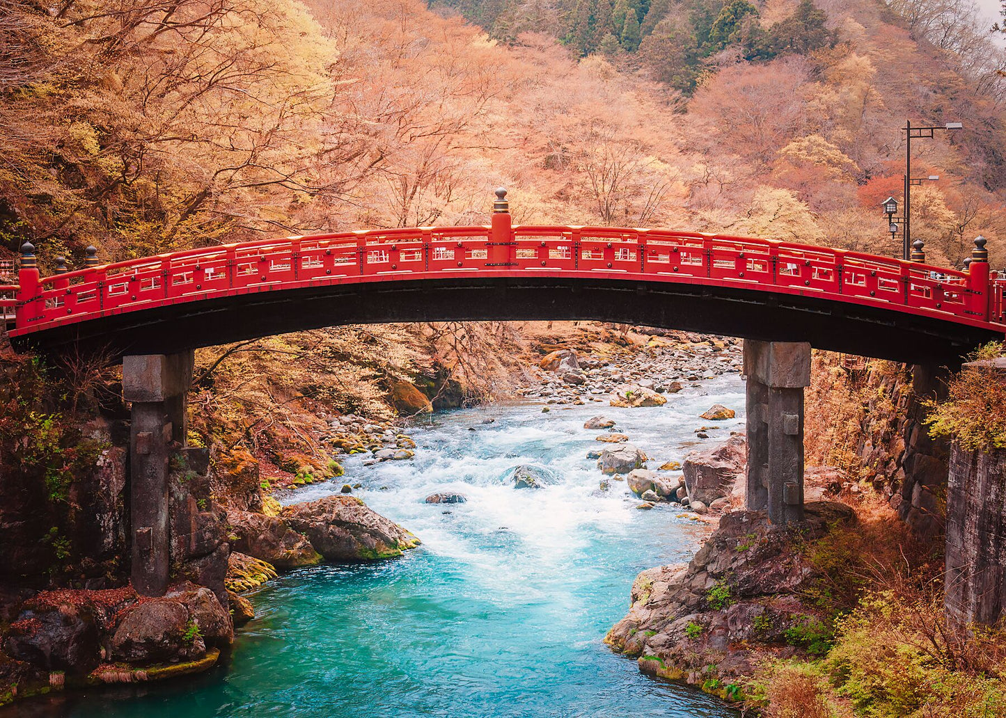 The iconic Shinkyo Bridge in Nikko, Japan, framed by lush nature.